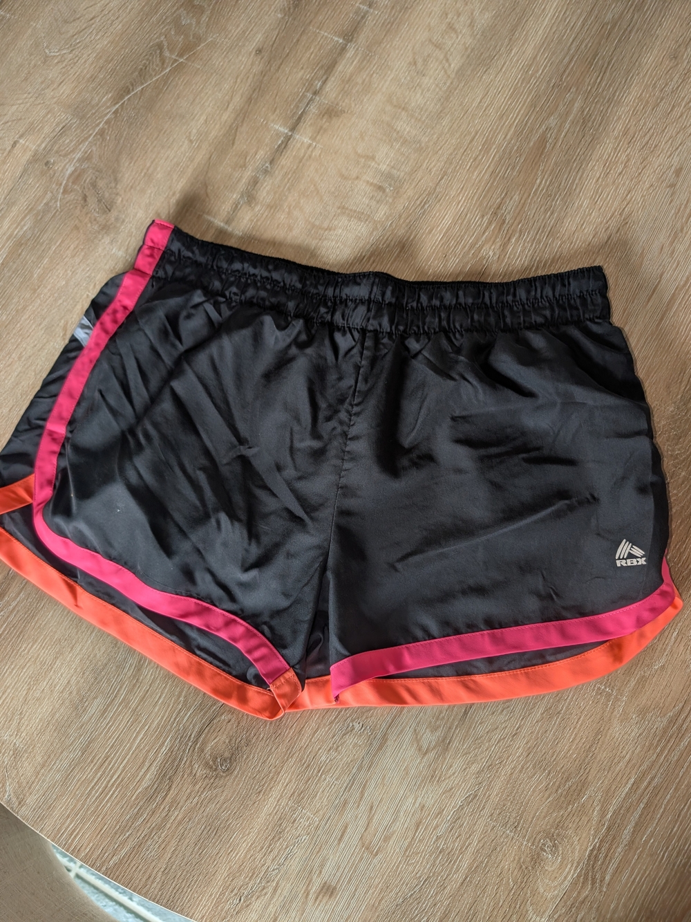 RBX Womenโs Black Active Shorts with Pink and Orange Trim